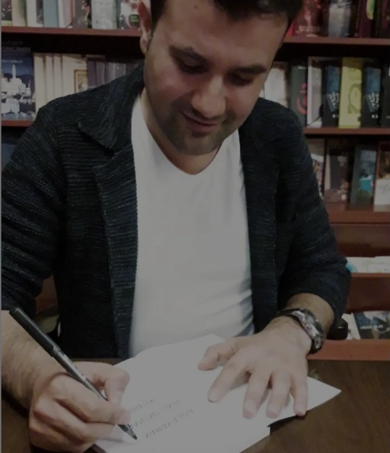 Türkolog Yusuf Güler kitabını imzalarken